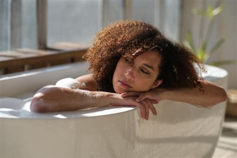 Premium Photo Smiling And Relaxing African American Woman Bathing In