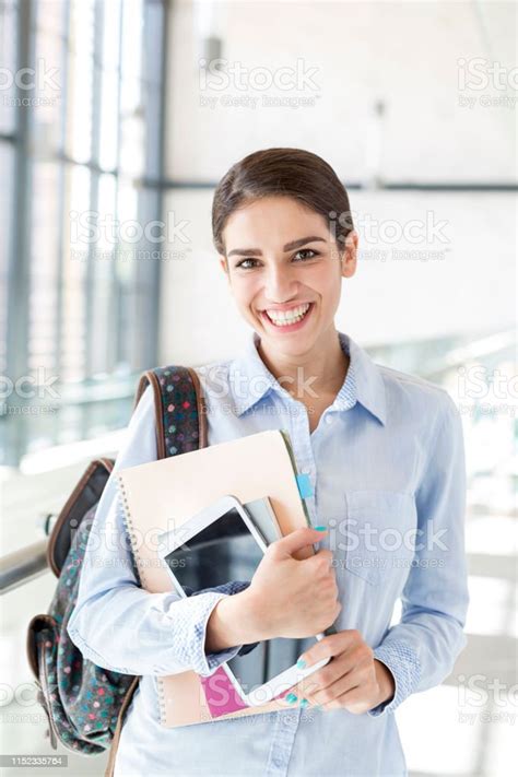 Portrait Of Teenage Girl With Books And Digital Tablet Standing In