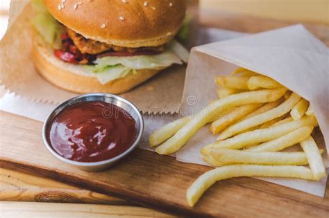 Fresh Tasty Burger And French Fries On Wooden Table French Fries And