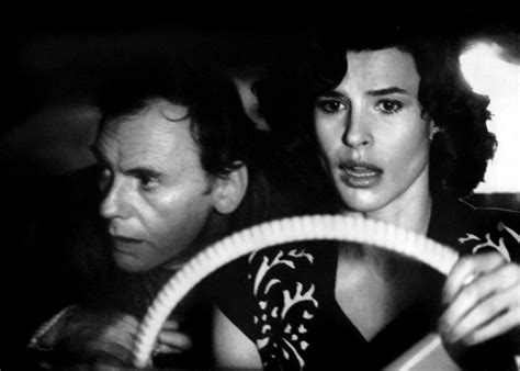 Black And White Photograph Of Man And Woman In Car Looking At Each