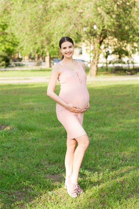 Pregnant Woman Enjoying And Relaxing Outside In The Park Pregnancy Maternity And Happiness