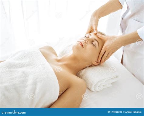 Beautiful Blonde Woman Enjoying Facial Massage With Closed Eyes Relaxing Treatment In Medicine