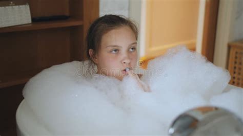 A Teenage Girl In The Bathtub Full Of Foam Relaxes Stock Footage