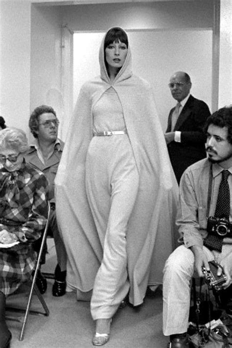 Anjelica Huston Models A Belted Knit Gown And Matching Hooded Cape On