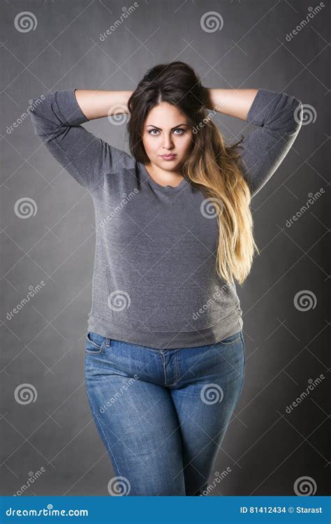 Young Beautiful Plus Size Model In Blue Jeans Xxl Woman On Gray