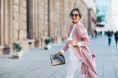 Elegant Young Woman Walking On The Sidewalk At Urban Setting Ambrelia