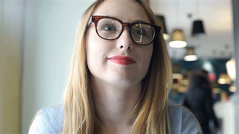 Pretty Girl With Red Lips Wearing Glasses And Relaxing In The Cafe