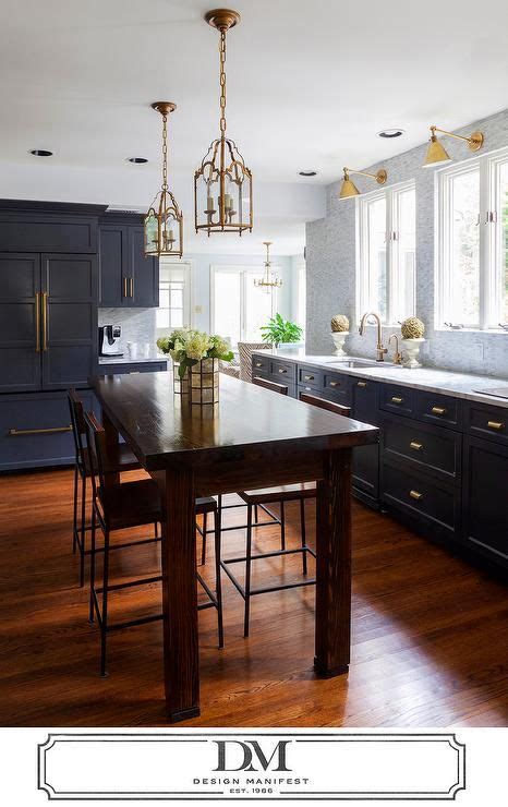 All white cabinetry with gold drawer pulls are a match made in (hipster) heaven. Beautiful kitchen features dark gray cabinets painted ...