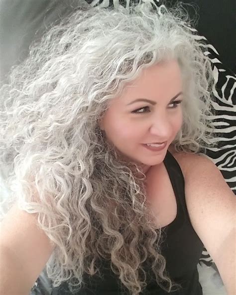 i love that i let my hair go natural the curl and the grey are all me long grey curly hair