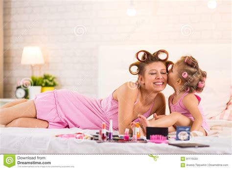 Mom And Daughter In The Bedroom On The Bed In The Curlers Make U Stock Image Image Of Cosmetic