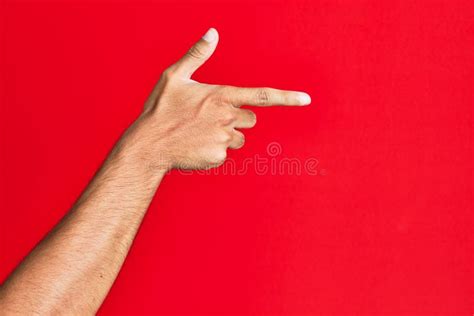 Arm Of Caucasian White Young Man Over Red Isolated Background Holding