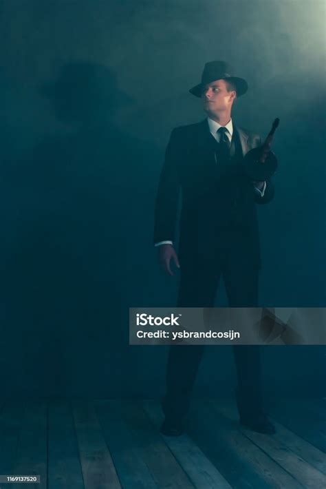 Retro Gangster Stands With Machine Gun In Smoke Stock Photo Download