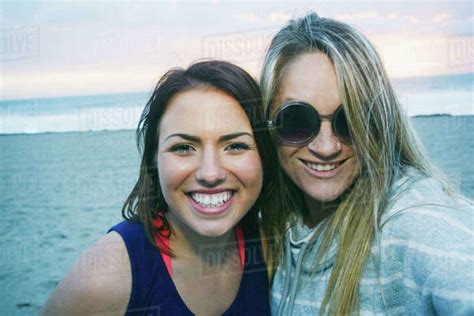 Portrait Of Smiling Caucasian Women At Beach Stock Photo Dissolve