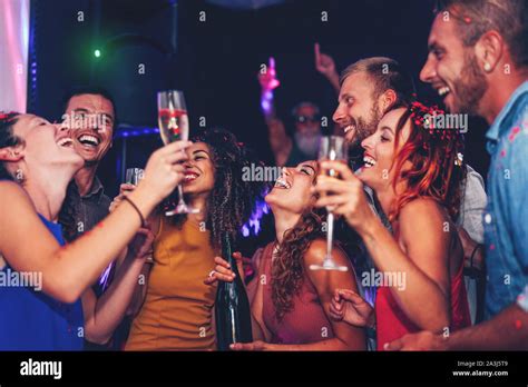 Group Of Friends Dancing And Drinking Champagne At Nightclub Party Happy Young People Having