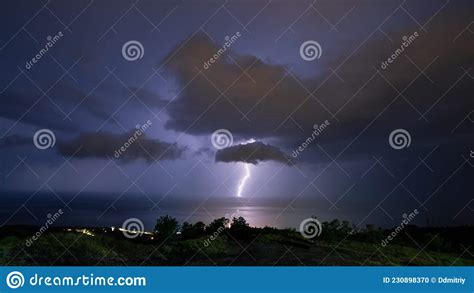 Night Thunderstorm Distant Illuminated Cumulonimbus Cloud And Blue Sky
