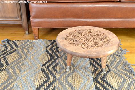 Learn how to make your own footstool by upholstering a side table with a hessian cushion. Remodelaholic | DIY Stool with Wood Burned Design