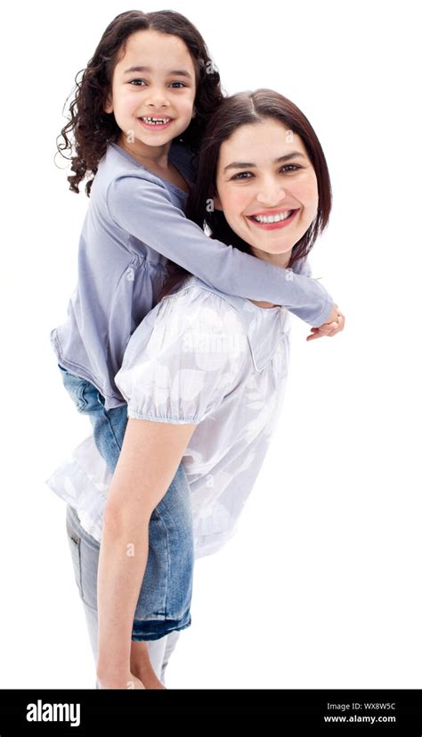 Beautiful Mother Giving Her Daughter Piggyback Ride Against A White