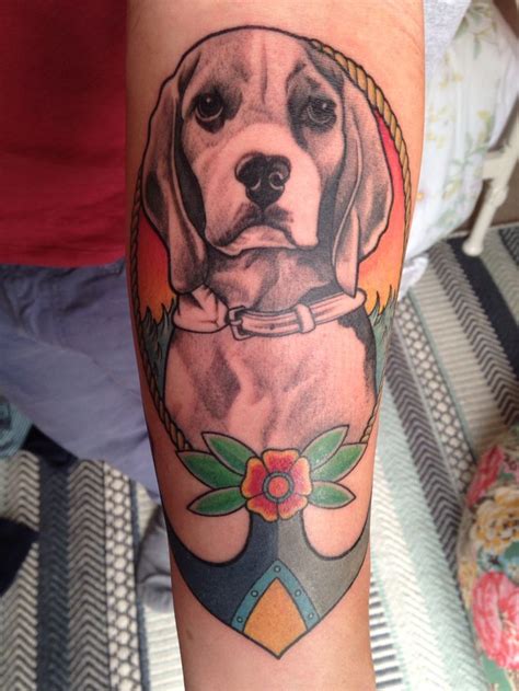 A Dog Tattoo On The Arm Of A Woman