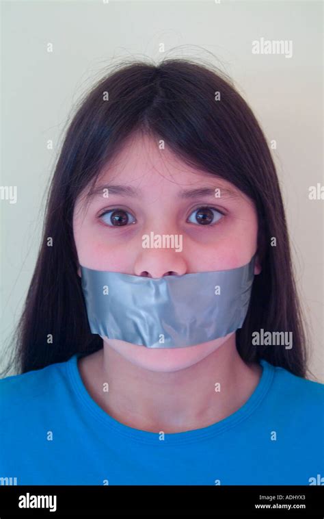 Young Girl With Tape Over Her Mouth To Illustrate Suppression Of