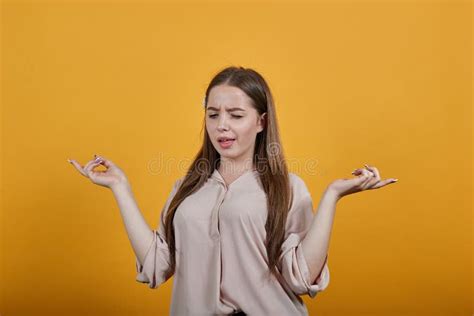 Happy Young Woman Winks Spreads Hands Showing Tongue Stock Image