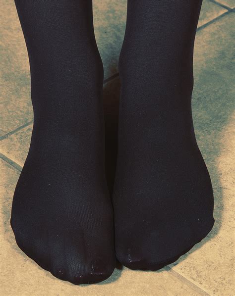 Women`s Legs And Feet In Tights Legs And Feet In Blue And Black Tights