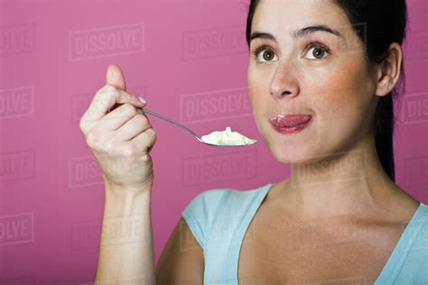 Woman Tasting Spoon Full Of Ice Cream Licking Lips Stock Photo Dissolve