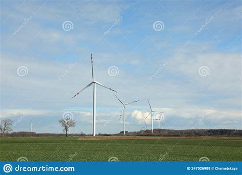 Modern Wind Turbines In Field On Sunny Day Alternative Energy Source
