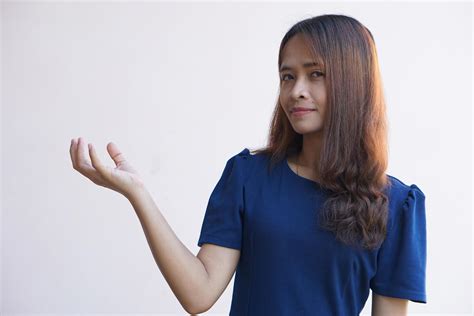 Asian Woman Extending Hand When Holding Goods 17521463 Stock Photo At