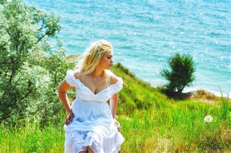 Portrait Of Young Romantic Woman In White Dress On Sea Background Stock