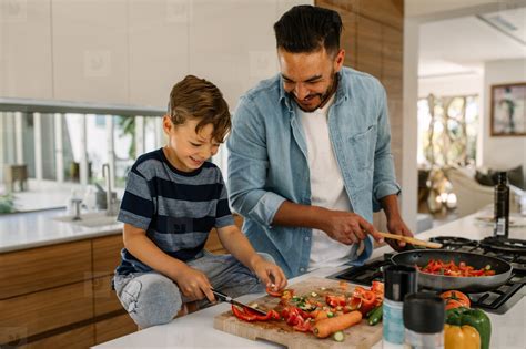 Photos - Father and son preparing food in kitchen 136620 - YouWorkForThem