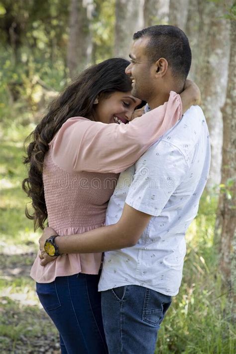 Asian Indian Married Couple Being Romantic In A Park Like Setting Stock