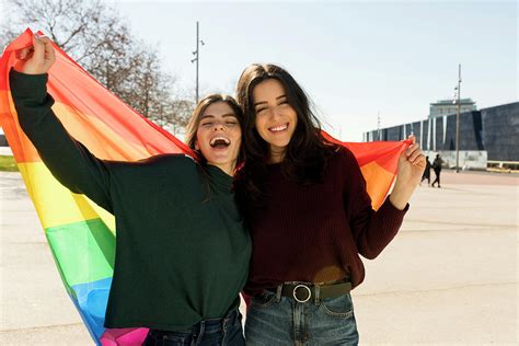 couple lesbian woman with gay pride flag in barcelona photograph by cavan images fine art america