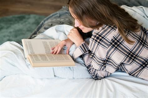 Free Photo Caucasian Woman Reading Book In Bed