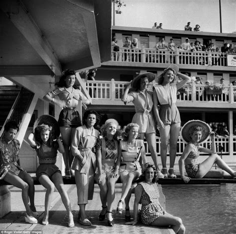 A Group Of Models Pose For Photographs During A Presentation Of Fashionable Beach Wear At A