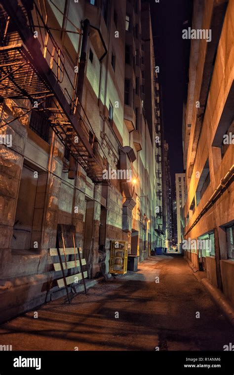 Dark And Eerie Downtown Urban City Alley With A Fire Escape Next At