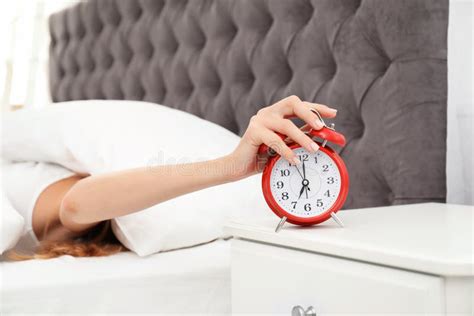 Woman Turning Off Alarm Clock Stock Photo Image Of Awake Indoors
