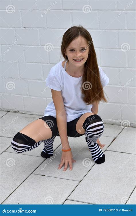 Teenage Girl Crouching Stock Image 72560113