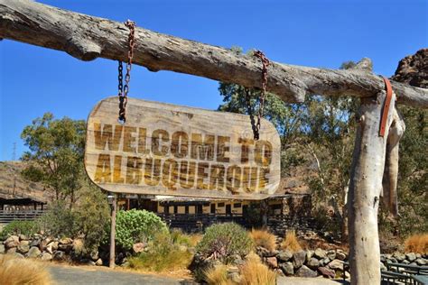 Old Wood Signboard With Text Welcome To Albuquerque Hanging On A