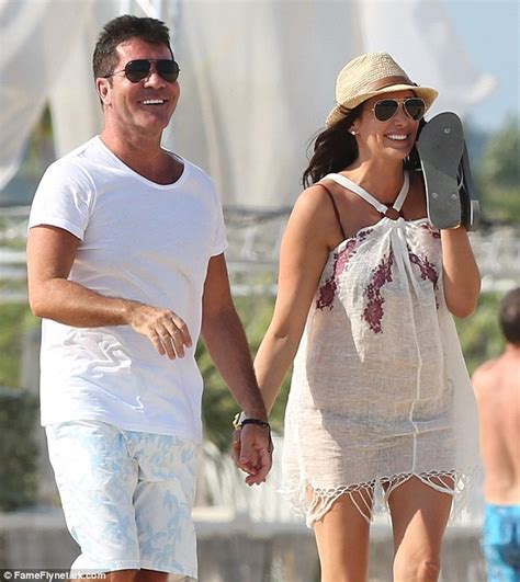 Simon Cowell Holds Hands With Pregnant Lauren Silverman During Beach