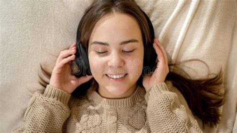 portrait of happy smiling teenage girl listening music and relaxing in bed stock image image
