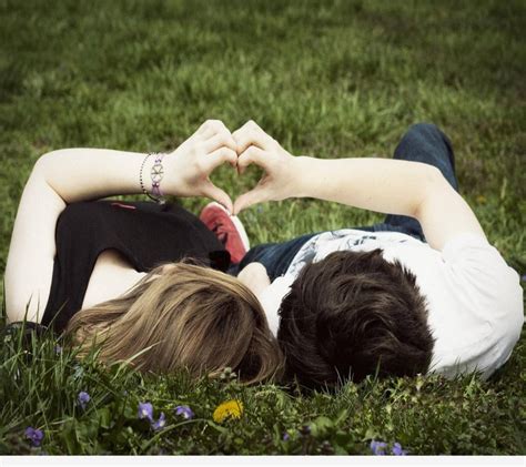 Download Cute Couple Making Cute Heart On Grass Wallpaper