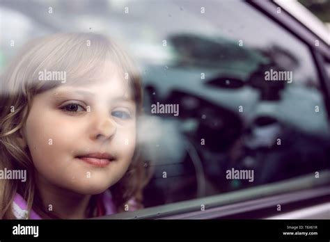 Cute Girl Looking Through The Car Window Stock Photo Alamy