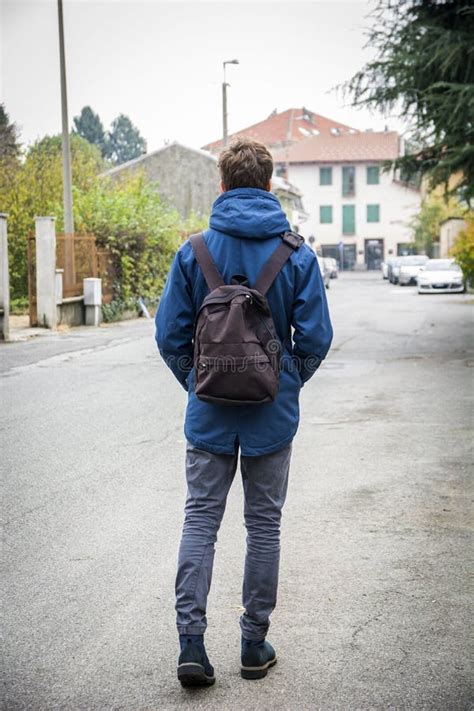 Teenage Boy Walking Alone In Street With Backpack Stock Photo Image