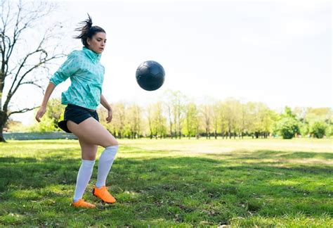 Premium Photo Portrait Of Young Woman Practicing Soccer Skills And