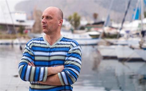 Businessman Standing By Expensive Sailing Boats And Yachts In A Stock