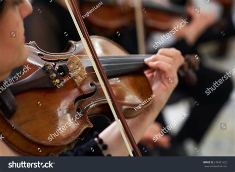 Women Violinist Playing Classical Violin Music In Musical Performance