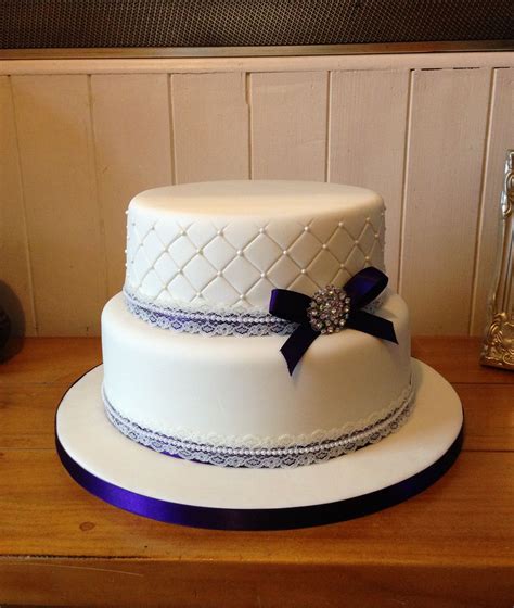 They're not too big, not too small, but just right. 2 tier ivory wedding cake with quilted top tier embossed ...
