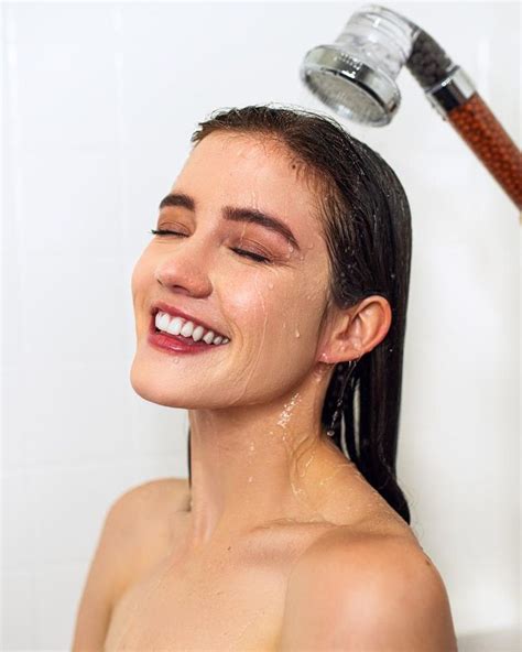 A Woman Is Smiling While She Takes A Shower