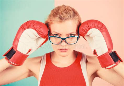 strong mentally and physically smart and strong woman boxing gloves adjust eyeglasses win