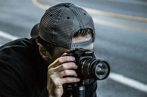 Man Taking Photo Using Black Canon Dslr Camera · Free Stock Photo